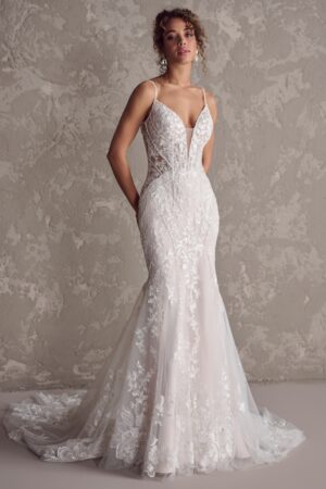 An elegant and romantic fit-and-flare, but make it edgy. There's nothing like a lace wedding dress with hip dips to make you feel like an absolute rockstar.